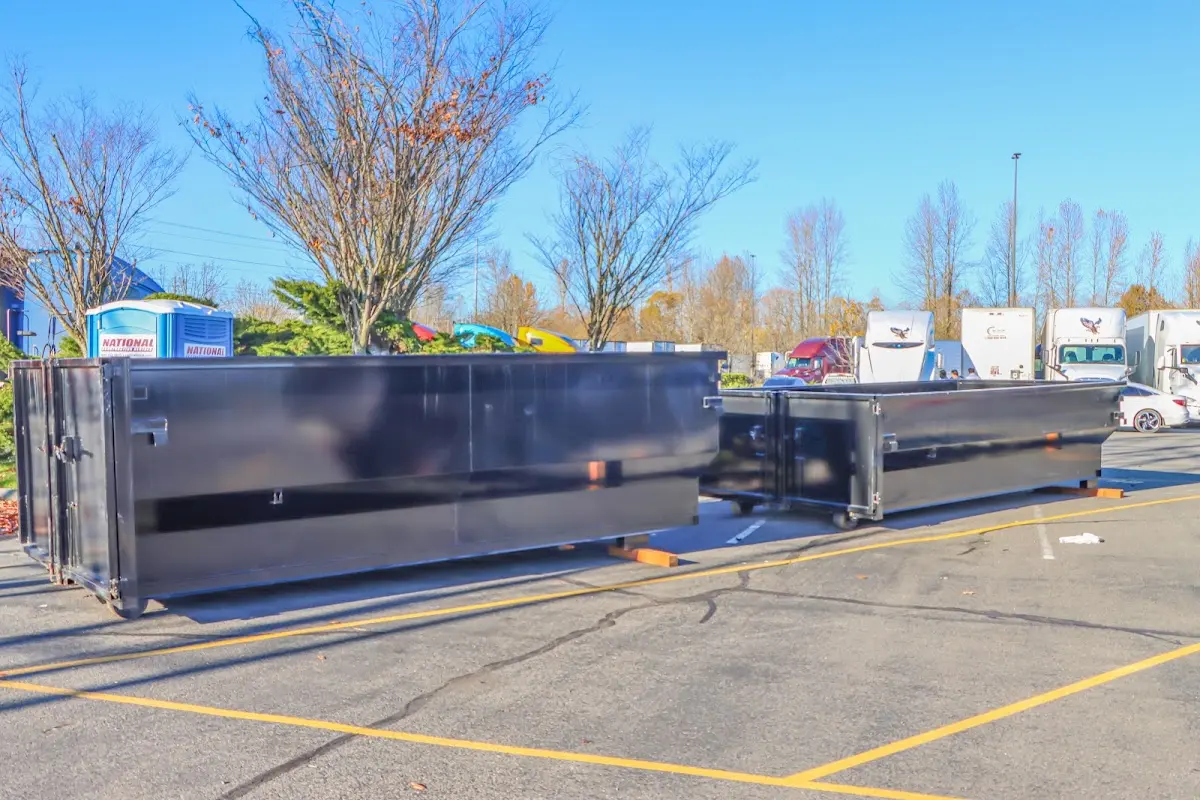 Professional dumpster rental service with roll-off container on residential driveway in Shelburne